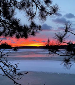 Beautiful sunset on lake in winter